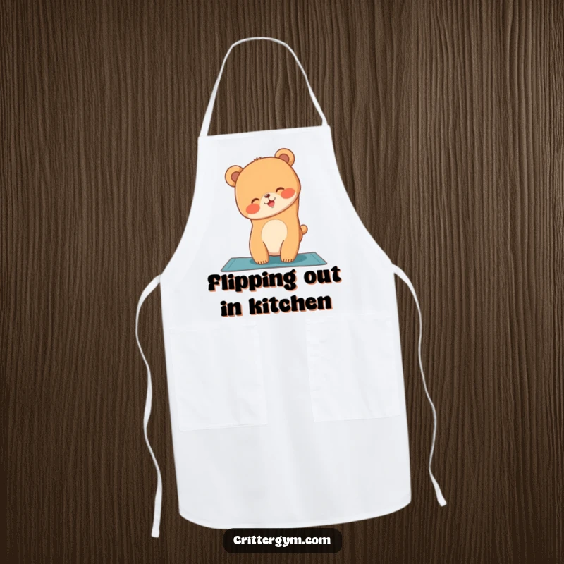 Funny bear cub attempting a handstand on a yoga mat, featured on a kitchen apron, a funny gift.