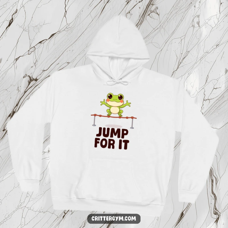Funny hoodie featuring a small, happy frog character leaping over tiny jump ropes with wide, excited eyes, perfect for cozy fun.