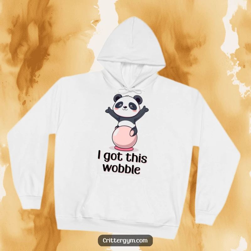 Funny kawaii panda character balancing on a yoga ball, featured on a soft, warm hoodie, a perfect funny gift.