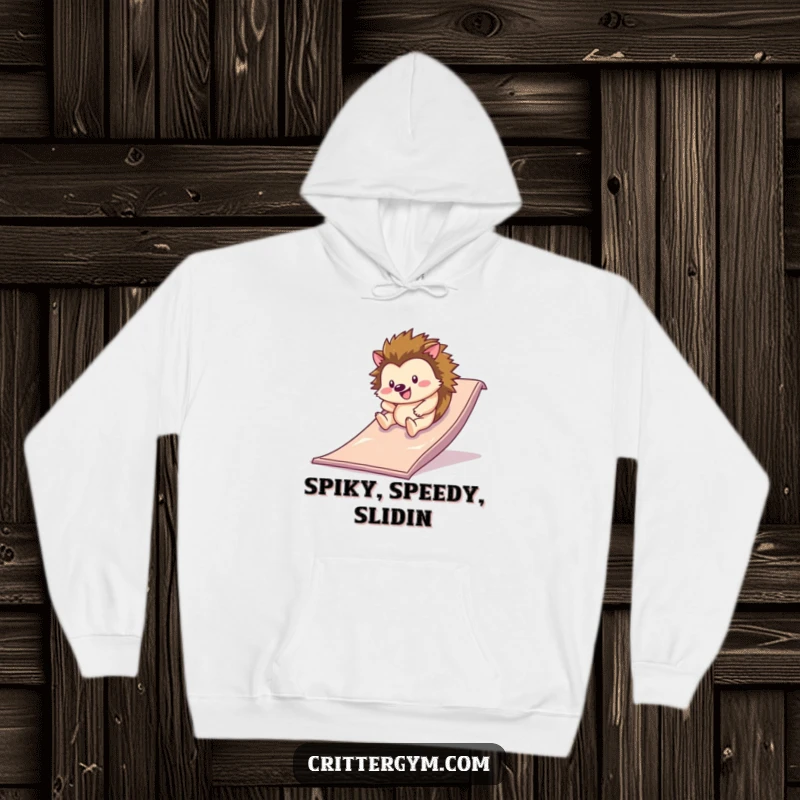 Funny hoodie with a happy hedgehog rolling down a slippery slide on a gym mat, offering warmth and a humorous, joyful vibe.