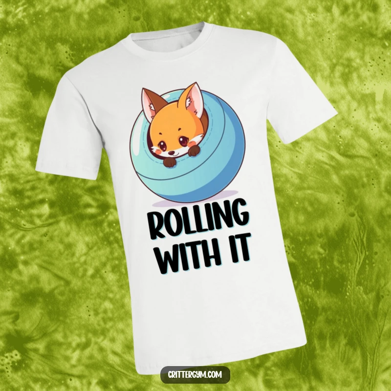 Funny t-shirt depicting a curious fox peeking from behind a large, colorful exercise ball, full of playful intrigue.