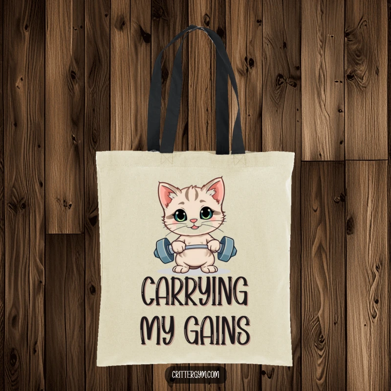 Funny proud kitten flexing after lifting tiny weights on a durable tote bag, a funny gift.